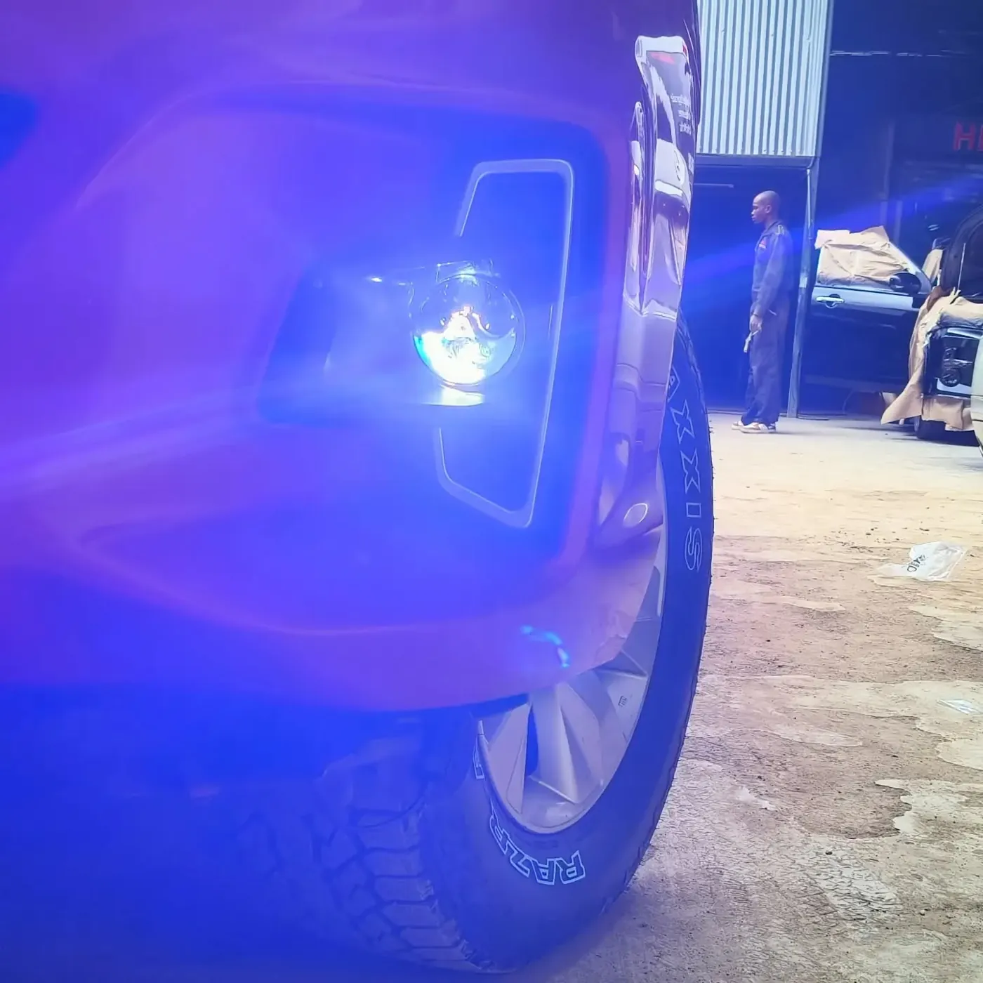 Blue accent lighting on a car at the workshop
