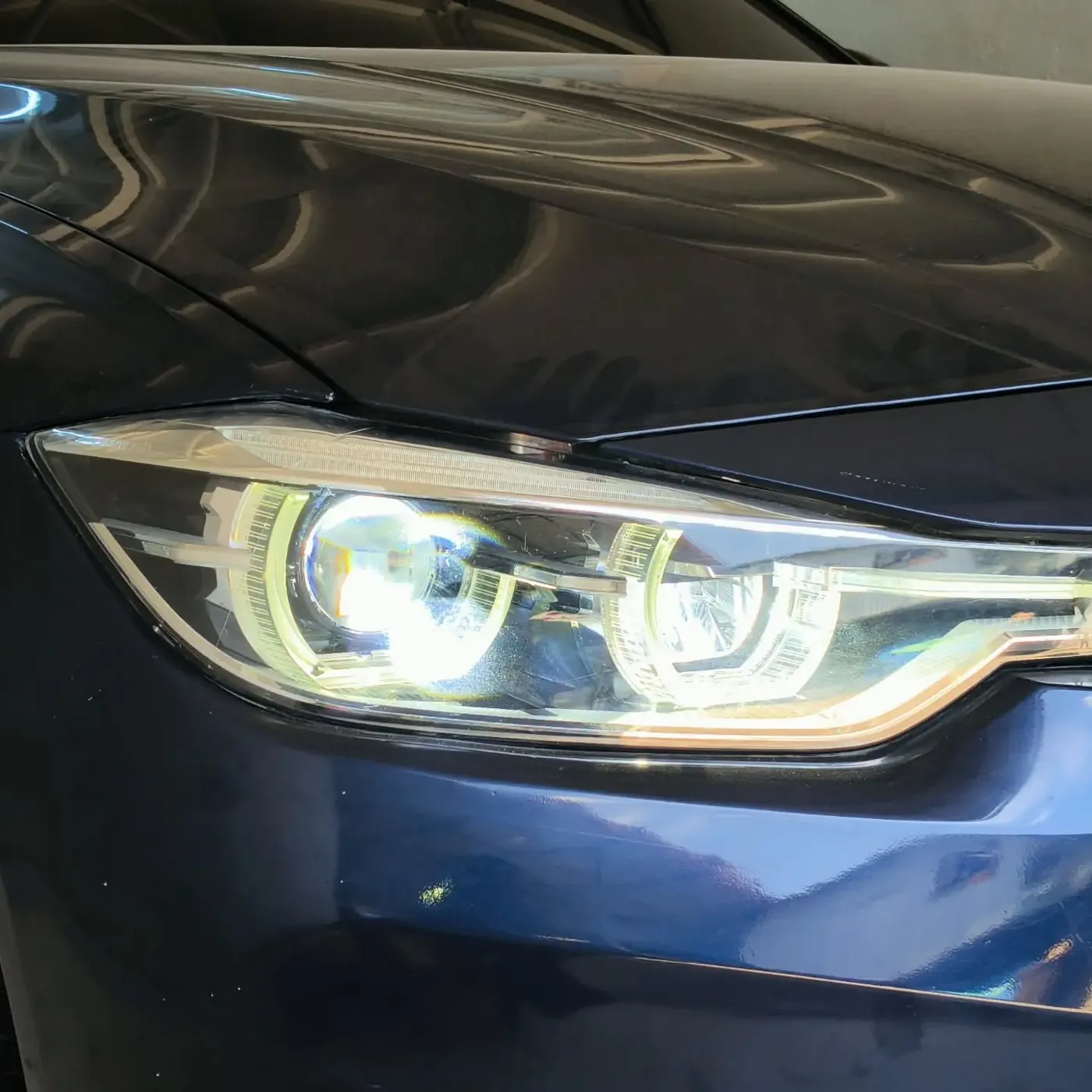 BMW headlight with twin projectors lit