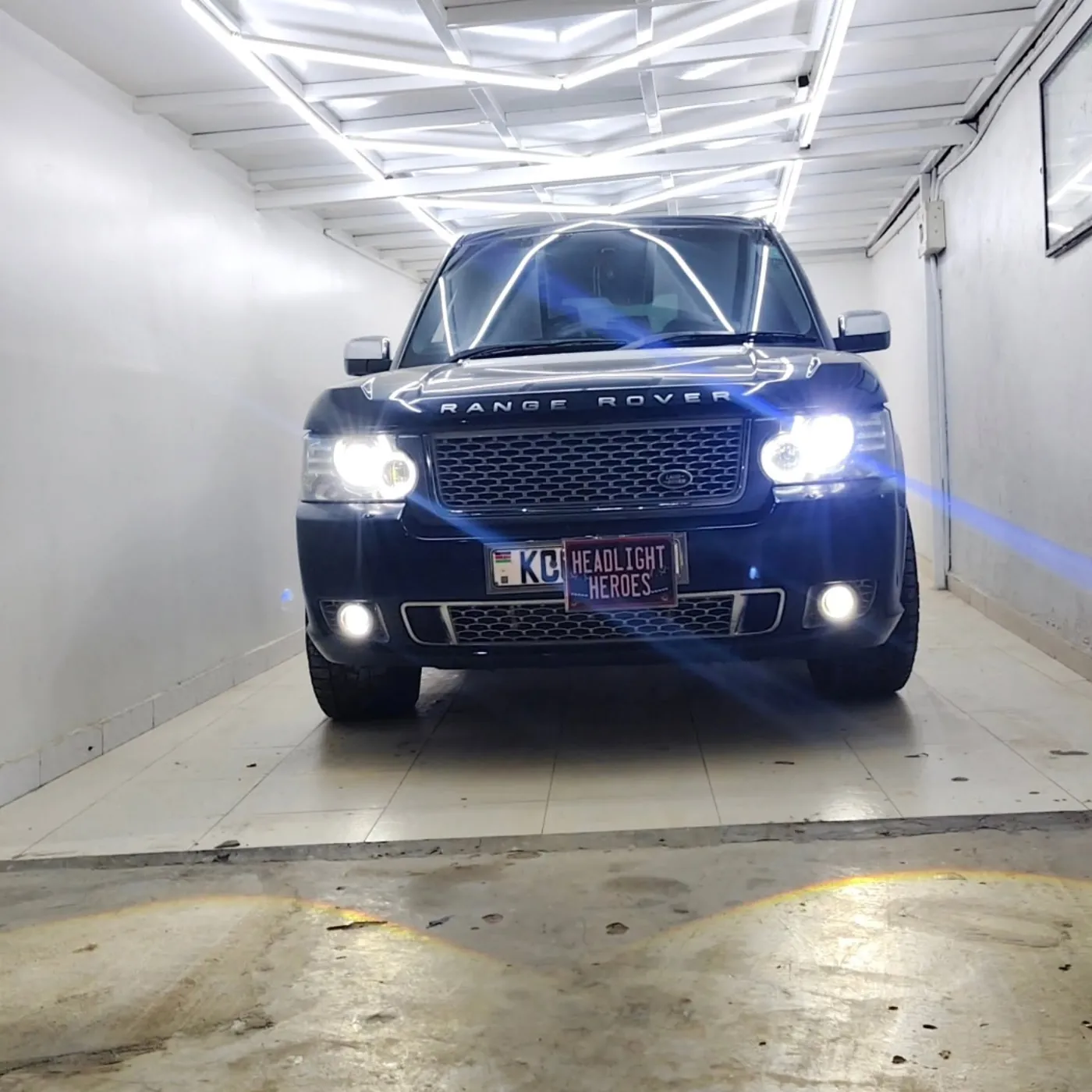 Range Rover with headlights and fog lights on in the Headlight Heroes bay