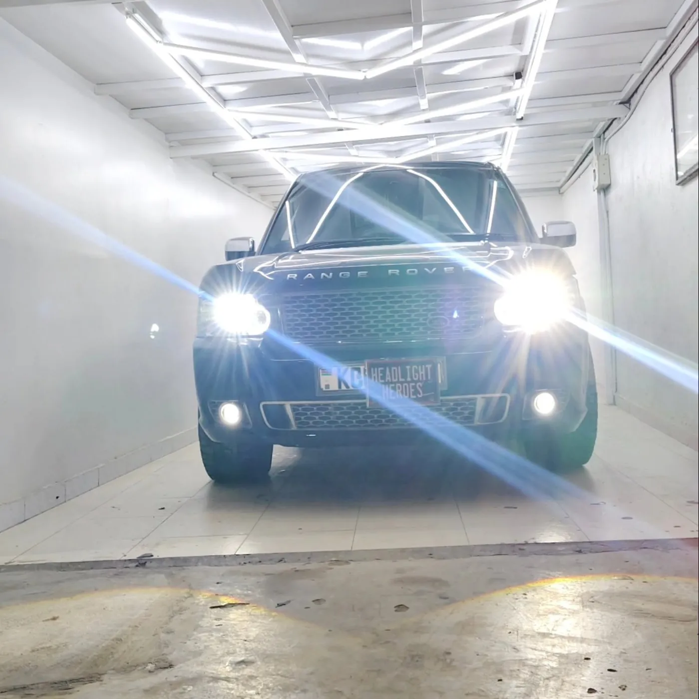 SUV in the bay with headlights and fog lights on